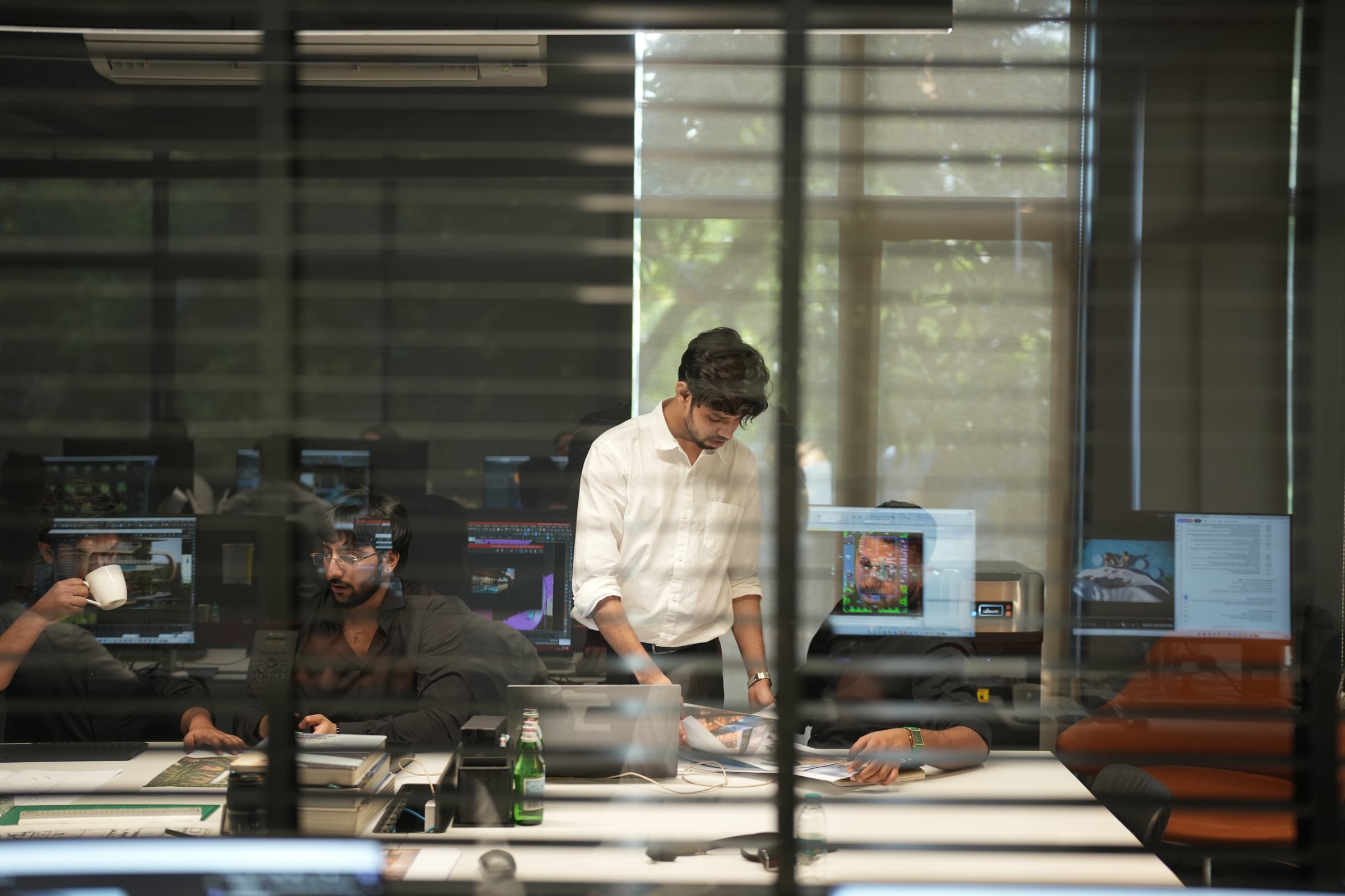 The Orange Sky team reviewing architectural imagery in the studio